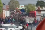 Momento del altercado entre locatarios y autoridades municipales durante un operativo de inspección y decomiso de pirotecnia irregular en el mercado de abastos de Querétaro, con presencia policial y concentración de personas.
