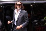 British comedian and actor Russell Brand arrives for the start of his trial at Southwark Crown Court in south London on October 12, 2026, after pleading not guilty to three charges of rape, indecent assault, and three counts of sexual assault. (Photo by Brook Mitchell / AFP)