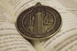 Medalla de San Benito en un libro