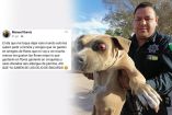 Policía Manuel Ibarra cargando a un perrito.