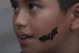 Niño con silueta de Batman en la mejilla. 