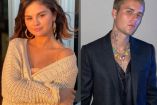 Selena Gomez con suéter blanco y Justin Bieber con traje negro