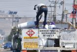 Repartidor de gas se encuentra arriba de un camión