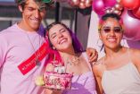 Los Polinesios vestidos de rosa con pastel y globos atrás