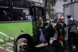 Migrantes abordando autobús