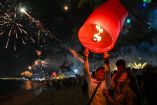 Una pareja suelta una linterna mientras la gente dispara fuegos artificiales para marcar la llegada del Año Nuevo en una playa de Sihanoukville, la capital costera de la provincia de Preah Sihanouk. Foto: AFP.