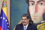 El presidente de Venezuela, Nicolás Maduro, durante una conferencia con un retrato de Simón Bolívar de fondo, discute medidas severas contra los crímenes de odio tras su reelección en un entorno de protestas y acusaciones de fraude electoral.