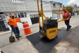 Hombres trabajando en la reparación de baches 