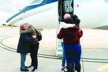 Italian humamitarian worker Alberto Trentini (L) and Italian businessman Mario Burlò are welcomed by their relatives following their release, as he arrives from Venezuela at Ciampino Airport in Rome on January 13, 2026. Venezuelan government announced it had released 116 detainees on January 12, 2026 morning, as the families of political prisoners grow impatient following the promise of release made by the authorities under U.S. pressure after the capture of President Nicolás Maduro. (Photo by Filippo ATTILI / various sources / AFP)