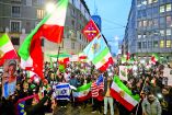 People hold flags and light up their phones outside the U.S. consulate during a rally in support of nationwide protests in Iran, in Milan, Italy, January 13, 2026. REUTERS/Claudia Greco