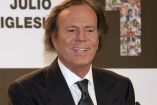 Julio Iglesias posa ante un fondo con su nombre durante un acto público en una imagen de archivo de 2011, vestido con traje oscuro y corbata, en un contexto informativo relacionado con su trayectoria artística.