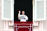 Pope Leo XIV addresses the crowd from the window of the apostolic palace overlooking St. Peter's square during the Angelus prayer in The Vatican on January 18, 2026. (Photo by Tiziana FABI / AFP)