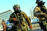 Members of law enforcement stand guard while people protest outside the Bishop Henry Whipple Federal Building, after the fatal shootings of Renee Nicole Good and Alex Pretti by federal immigration agents, in Minneapolis, Minnesota, U.S., January 30, 2026. REUTERS/Shannon Stapleton