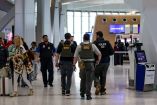 Immigration and Customs Enforcement (ICE) agents walk at Newark Liberty International Airport, as hundreds of them were ordered to deploy to airports to help fill TSA staffing gaps, in Newark, New Jersey, U.S., March 23, 2026. REUTERS/Jeenah Moon