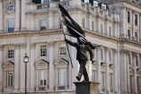 A statue depicting a person stepping off the plinth while carrying a flag covering their face, by British street artist Banksy, stands in London, Britain, April 30, 2026. REUTERS/Jack Taylor