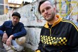 Members of Bosnian Hip-Hop band "Dubioza Kolektiv", Brano Jakubovic (L) and Vedran Mujagic pose with a ball in Sarajevo on June 2, 2026. With brass, guitars, and a music video overflowing with grilled meat, Bosnia has delivered the first World Cup anthem of 2026: "I Am from Bosnia, Take Me to America." the song had already accumulated several million views on different platforms. The song is a cover version of an earlier hit by the Bosnian rock band Dubioza Kolektiv and is rapidly becoming one of the signature songs (anthems) of the 2026 World Cup, which begins on June 11. (Photo by ELVIS BARUKCIC / AFP)