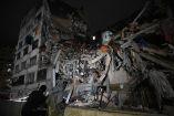 TOPSHOT - People look at a collapsed building in the Altamira neighbourhood following an earthquake in Caracas on June 24, 2026. Two earthquakes of magnitude 7.2 and 7.5 struck the same area of Venezuela on the evening of June 24, causing buildings to collapse, according to the United States Geological Survey (USGS) and AFP journalists. The quakes drove residents of the capital, Caracas, into the streets. (Photo by Federico PARRA / AFP)