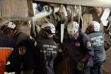This handout image released by the Miami Fire-Rescue Department shows rescuers working inside a collapsed building as they attempt to reach Hernan Gil, who survived for nearly eight days beneath the rubble of a building on the verge of collapse in Catia La Mar, La Guaira state, Venezuela on July 2, 2026, after the June 24 twin earthquakes. Gil was rescued on July 2, 2026 through a tunnel roughly three meters long dug by rescue workers from seven countries, who had worked tirelessly, supplying him with water and air via probes and a hose. (Photo by Handout / City of Miami Fire-Rescue / AFP) / RESTRICTED TO EDITORIAL USE - MANDATORY CREDIT "AFP PHOTO / Miami Fire-Rescue Department" - NO MARKETING NO ADVERTISING CAMPAIGNS - DISTRIBUTED AS A SERVICE TO CLIENTS