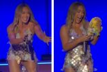 Hilary Duff recibe un pelcuche Dr. Simi con su vestido de estrellas durante un concierto