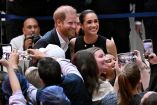(FILES) Britain's Prince Harry (L), Duke of Sussex, and his wife Meghan (R), the Duchess of Sussex, meet people at the Royal Children's Hospital in Melbourne on April 14, 2026. Britain's Prince Harry and his wife Meghan will on Thursday, October 15, carry out their first joint engagement since returning to live in the UK in August, according to media reports. (Photo by William WEST / AFP)