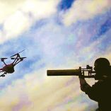 Militar apuntando un arma contra un dron.