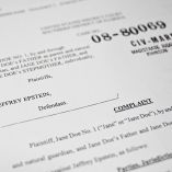 La fotoilustración muestra un documento judicial después de que el Departamento de Justicia de EE. UU. comenzara a publicar los registros largamente esperados de la investigación sobre el caso políticamente explosivo del delincuente sexual convicto Jeffrey Epstein.