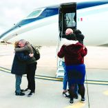 Italian humamitarian worker Alberto Trentini (L) and Italian businessman Mario Burlò are welcomed by their relatives following their release, as he arrives from Venezuela at Ciampino Airport in Rome on January 13, 2026. Venezuelan government announced it had released 116 detainees on January 12, 2026 morning, as the families of political prisoners grow impatient following the promise of release made by the authorities under U.S. pressure after the capture of President Nicolás Maduro. (Photo by Filippo ATTILI / various sources / AFP)