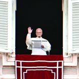 Pope Leo XIV addresses the crowd from the window of the apostolic palace overlooking St. Peter's square during the Angelus prayer in The Vatican on January 18, 2026. (Photo by Tiziana FABI / AFP)