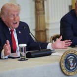 WASHINGTON, DC - JANUARY 16: U.S. President Donald Trump (L) speaks as U.S. Secretary of Health and Human Services Robert F. Kennedy Jr. looks on during a "Great, Historic Investment in Rural Health Roundtable" in the East Room of the White House on January 16, 2026 in Washington, DC. Trump promoted a 50-state, $50 billion rural health program that aims to help communities where hospitals are struggling and residents have a hard time finding care, made worse by Republican-led Medicaid cuts that were part of 2025's One Big Beautiful Bill.   Chip Somodevilla/Getty Images/AFP (Photo by CHIP SOMODEVILLA / GETTY IMAGES NORTH AMERICA / Getty Images via AFP)