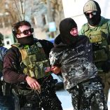 Federal agents detain a protester in Minneapolis, Minnesota on February 3, 2026. A US judge on January 31, 2026 denied Minnesota's bid to force Immigration and Customs Enforcement (ICE) to suspend its sweeping detention and deportation operation in the state that has left two US citizens dead and fueled massive protests. Masked and heavily armed federal agents have swept through Minnesota communities seeking undocumented migrants, detaining thousands and shooting dead two US citizens in the process. (Photo by Charly TRIBALLEAU / AFP) / ALTERNATE CROP
