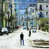 TOPSHOT - People walk along a quiet street in Havana on February 8, 2026. The Cuban government on February 6 announced emergency measures to address a crippling energy crisis worsened by US sanctions, including the adoption of a four-day work week for state-owned companies and fuel sale restrictions. (Photo by ADALBERTO ROQUE / AFP)
