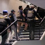 FBI and DEA personnel walk at the venue, following a shooting incident during the annual White House Correspondents' Association dinner, in Washington, D.C., U.S., April 25, 2026. REUTERS/Ken Cedeno