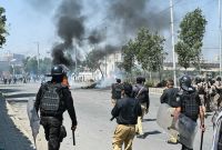 Police fire tear gas at Shiite Muslims as they stage protests in solidarity with Iran, outside the US consulate in Karachi on March 1, 2026. Iranian state television confirmed the death of its supreme leader Ayatollah Ali Khamenei and launched a fresh wave of attacks on March 1, as Israel hit back at the capital Tehran. In Pakistan, eight people were killed as hundreds of protesters tried to storm the US consulate in the megacity of Karachi, the local rescue service said. (Photo by Asif HASSAN / AFP)