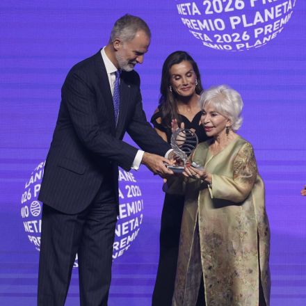 Spain's King Felipe VI (L) and Queen Letizia present the winner of Spain's 2026 Premio Planeta Award, Chilean writer Isabel Allende (R), with the trophy during the ceremony of the 75th edition of the "Premio Planeta" award at the Fira convention center in Barcelona on October 15, 2026. (Photo by Lluis GENE / AFP)