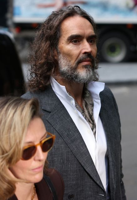 British comedian and actor Russell Brand arrives for the start of his trial at Southwark Crown Court in south London on October 12, 2026, after pleading not guilty to three charges of rape, indecent assault, and three counts of sexual assault. (Photo by Brook Mitchell / AFP)