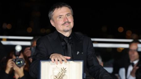 Romanian director, screenwriter and producer Cristian Mungiu poses with the trophy during a photocall after winning the Palme d'Or for the film "Fjord" during the closing ceremony of the 79th edition of the Cannes Film Festival in Cannes, southern France, on May 23, 2026. (Photo by Thibaud MORITZ / AFP)