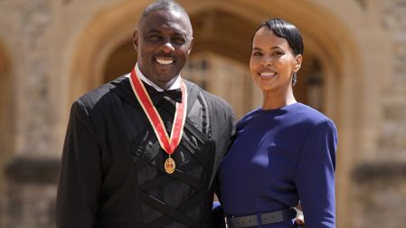British actor Idris Elba poses with his wife Sabrina Dhowre Elba and his medal after being appointed as a Knight Bachelor (Knighthood) for services to young people at an investiture ceremony at Windsor Castle on June 2, 2026. (Photo by Andrew Matthews / POOL / AFP)