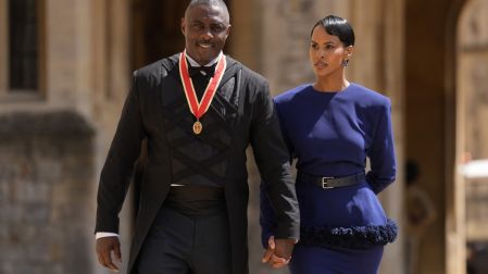 British actor Idris Elba poses with his wife Sabrina Dhowre Elba and his medal after being appointed as a Knight Bachelor (Knighthood) for services to young people at an investiture ceremony at Windsor Castle on June 2, 2026. (Photo by Andrew Matthews / POOL / AFP)