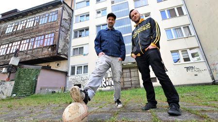 Members of Bosnian Hip-Hop band "Dubioza Kolektiv", Brano Jakubovic (L) and Vedran Mujagic pose with a ball in the backyard of an apartment block, in Sarajevo on June 2, 2026. With brass, guitars, and a music video overflowing with grilled meat, Bosnia has delivered the first World Cup anthem of 2026: "I Am from Bosnia, Take Me to America." the song had already accumulated several million views on different platforms. The song is a cover version of an earlier hit by the Bosnian rock band Dubioza Kolektiv and is rapidly becoming one of the signature songs (anthems) of the 2026 World Cup, which begins on June 11. (Photo by ELVIS BARUKCIC / AFP)
