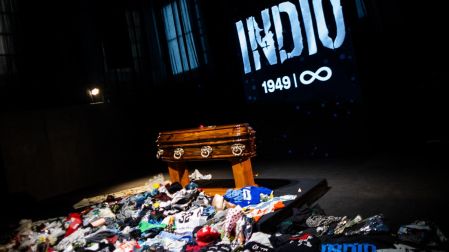 The coffin with the remains of Carlos Alberto "Indio" Solari, the iconic Argentine rock musician and former lead singer of Patricio Rey y sus Redonditos de Ricota, is pictured as fans queue to pay their respects at Villa Dominico, Buenos Aires Province, Argentina, on June 7, 2026. The singer died in Parque Leloir, Buenos Aires Province, on June 5 at the age of 77. (Photo by TOMAS CUESTA / AFP)