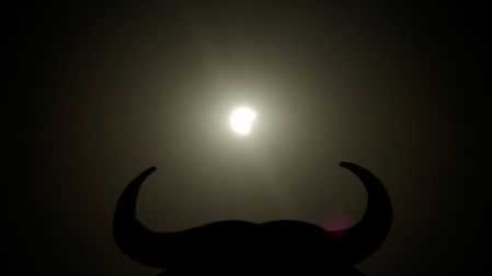 The moon partially covers the sun during a solar eclipse near the silhouette of an Osborne Bull, in Navarrete, northern Spain, August 12, 2026. REUTERS/Vincent West REFILE - ADDING INFORMATION     TPX IMAGES OF THE DAY