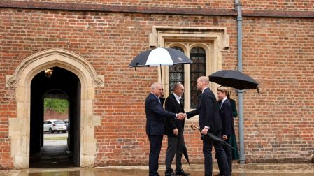 Britain's Prince William, Prince of Wales (2nd R), Britain's Catherine, Princess of Wales (behind R) and their 13-year-old son, Britain's Prince George of Wales (R), are met by headmaster Simon Henderson (2nd L) and provost Nicholas Coleridge (L) as Prince George arrives for his first day at Eton College, in Eton, west of London, on September 8, 2026. (Photo by Adrian DENNIS / POOL / AFP)