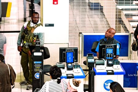 A U.S. Immigration and Customs Enforcement (ICE) agent patrols a TSA security checkpoint in Baltimore/Washington International Thurgood Marshall Airport (BWI) in Baltimore, Maryland, U.S., March 29, 2026. REUTERS/Aaron Schwartz     TPX IMAGES OF THE DAY