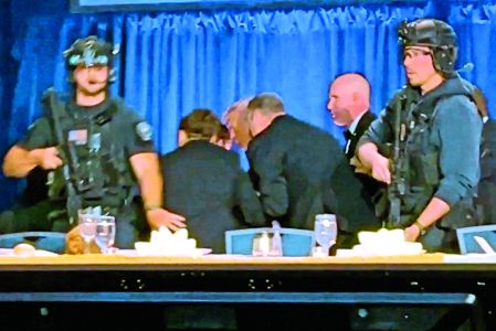 U.S. President Donald Trump is escorted out as a shooter opens fire during the annual White House Correspondents' Association dinner in Washington, D.C., U.S., April 25, 2026, in this screen capture from video. REUTERS/Bo Erickson THIS IMAGE WAS PROCESSED BY REUTERS TO ENHANCE QUALITY, AN UNPROCESSED VERSION HAS BEEN PROVIDED SEPARATELY.     TPX IMAGES OF THE DAY
