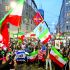 People hold flags and light up their phones outside the U.S. consulate during a rally in support of nationwide protests in Iran, in Milan, Italy, January 13, 2026. REUTERS/Claudia Greco