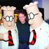 FILE PHOTO: Scott Adams, the creator of "Dilbert", the cartoon character that lampoons the absurdities of corporate life, poses with two "Dilbert" characters at a party January 8, 1999 in Pasadena. The party celebrated the new half-hour animated series "Dilbert", which  debuts on the UPN television network January 25./File Photo