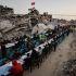 Palestinians gather to break their fast by eating Iftar meals on the first day of the holy month of Ramadan, near the rubble of residential buildings destroyed during the two-year Israeli offensive, in Gaza City, February 18, 2026. REUTERS/Dawoud Abu Alkas