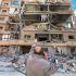 A man points at a building damaged by Israeli strikes, amid escalating hostilities between Israel and Hezbollah, as the U.S.-Israeli conflict with Iran continues, in Beirut's southern suburbs, Lebanon, March 28, 2026. Picture taken with a mobile phone. REUTERS/Stringer     TPX IMAGES OF THE DAY