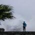 A person looks on as large waves crash against the coast as Typhoon Bavi passes off northeastern Taiwan, in Keelung on July 11, 2026. (Photo by I-Hwa Cheng / AFP)