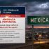 Letrero con el nombre de la ciudad de Mexicali y una alerta de seguridad de EU.
